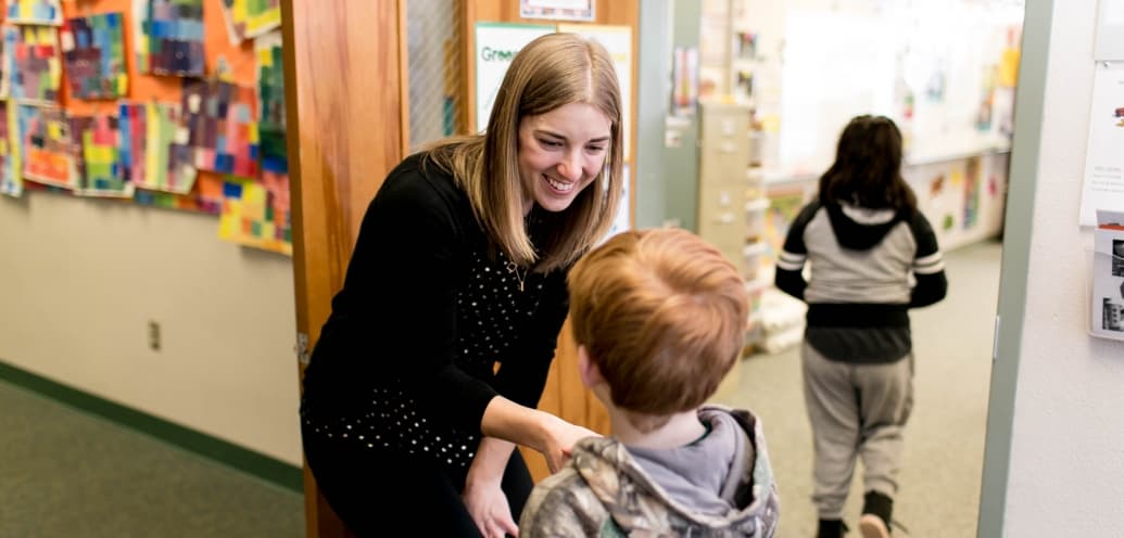 Teacher of the Year Camille Jones shakes student's hand