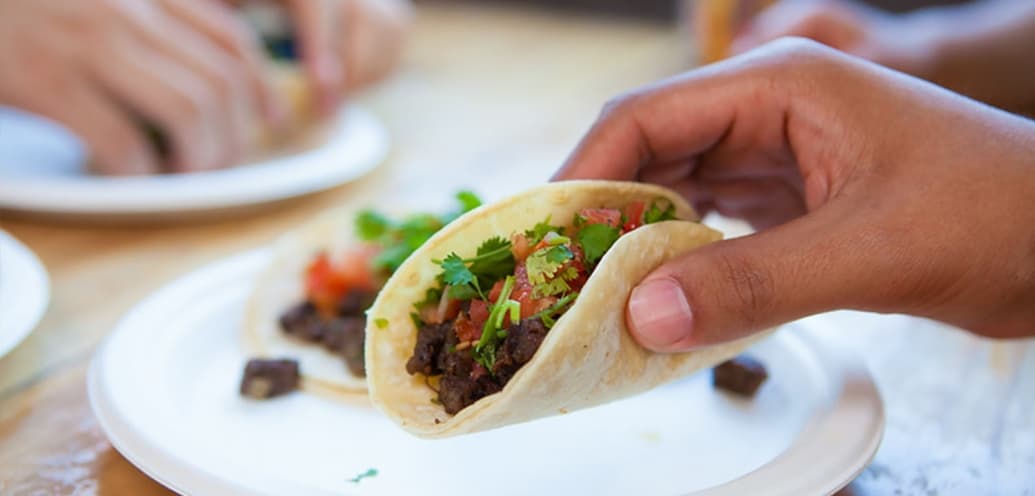 Hand holding a taco