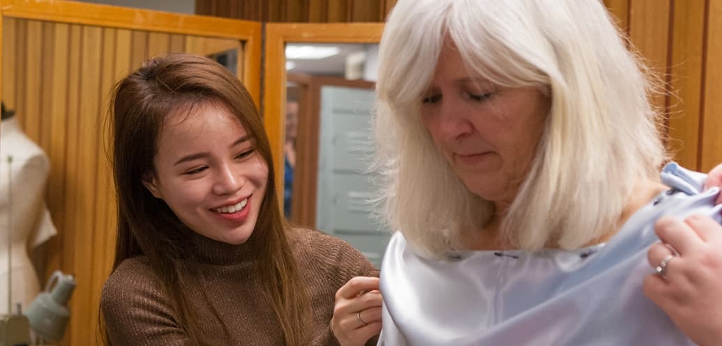 Syl Xu works on fitting Louise Furrow's dress