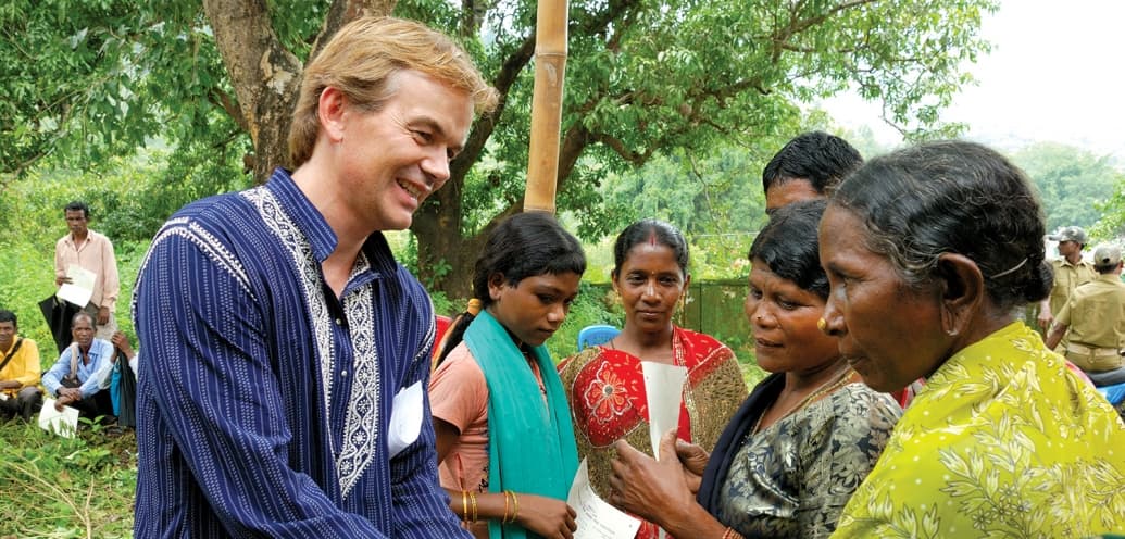 Tim Hanstad '85, co-founder of Landesa, meets with families.