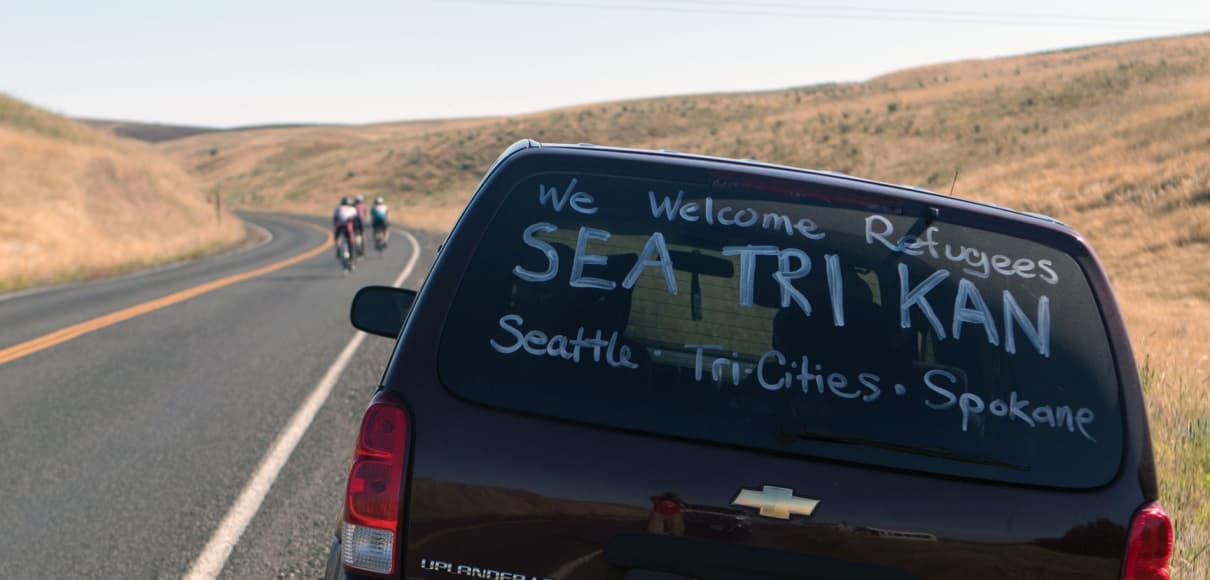 back view of van with bikers in the distance