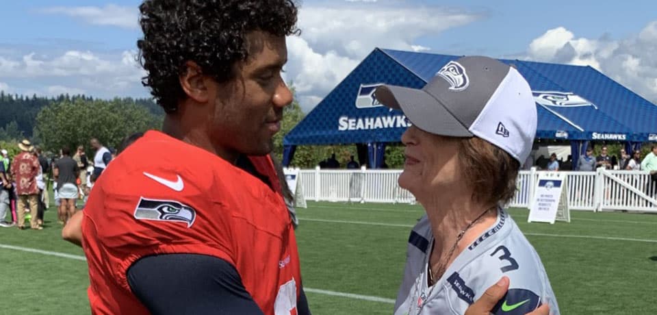 Seahawks quarterback Russell Wilson with SPU alum Joy Staley