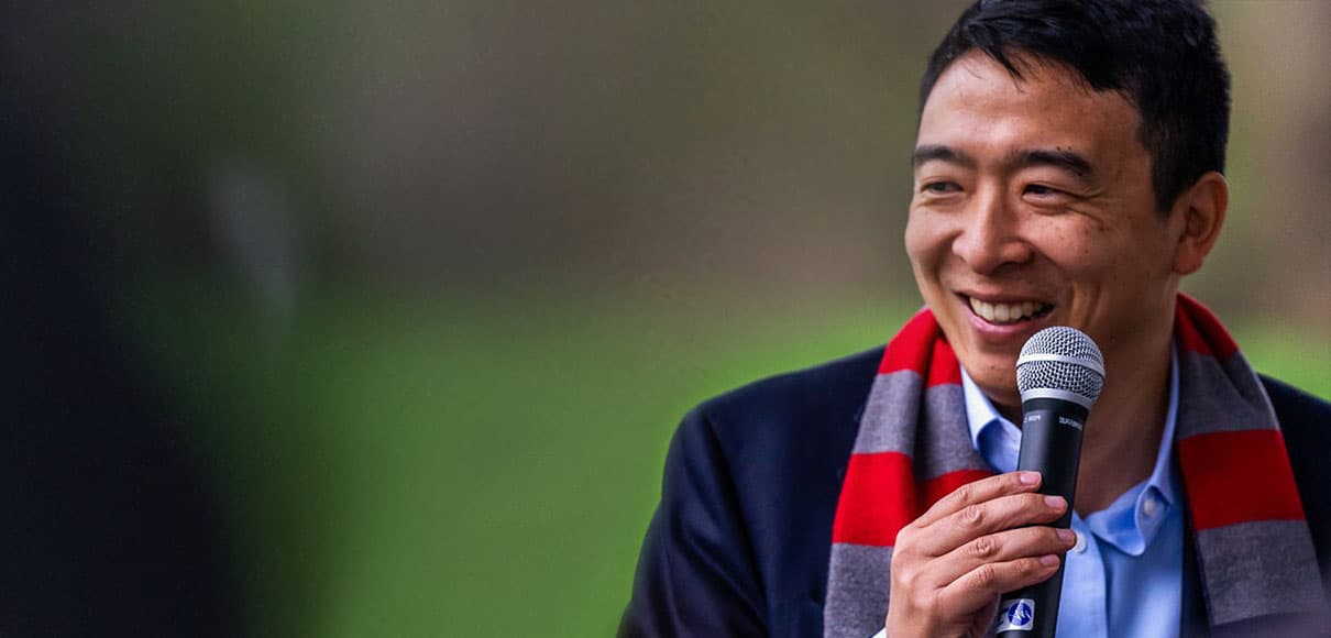 Andrew Yang smiles during a speaking engagement