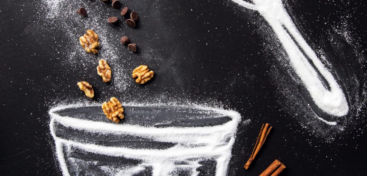 A mixing bowl and mixer, drawn with sugar on a black countertop Photo illustration by Brittany Fan