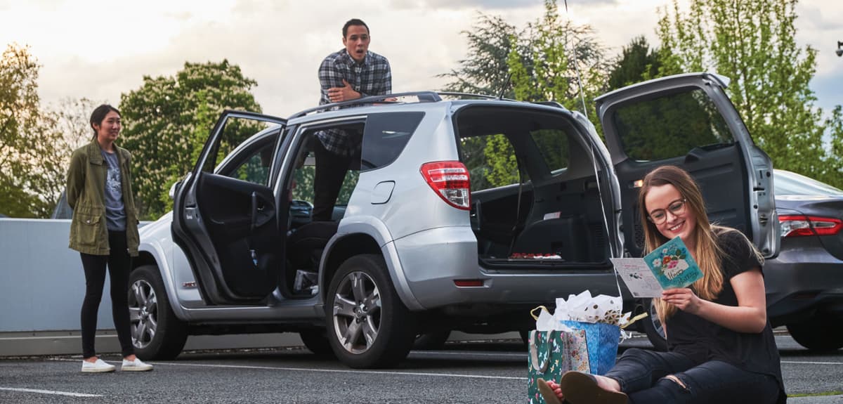 Students hang out in the Dravus parking lot, celebrating a socially-distanced birthday