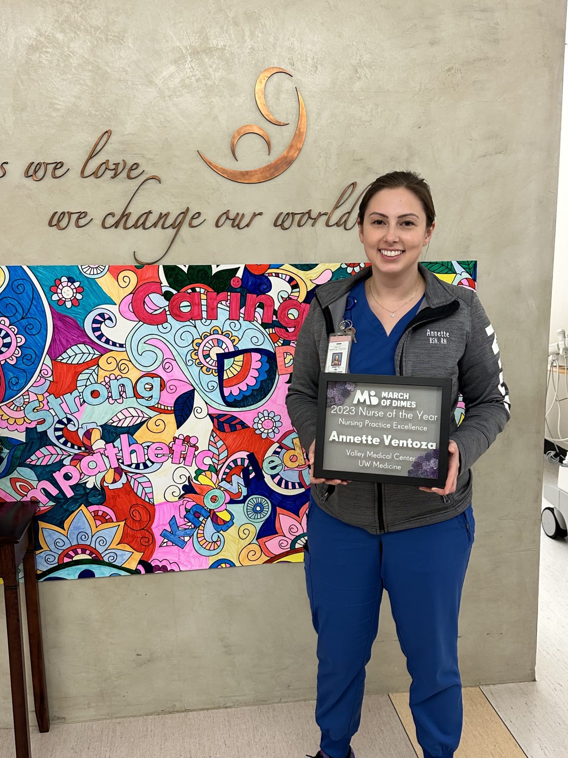 Nursing alumna Annette Ventoza holds a plaque awarding her the March of Dimes Nurse of the Year