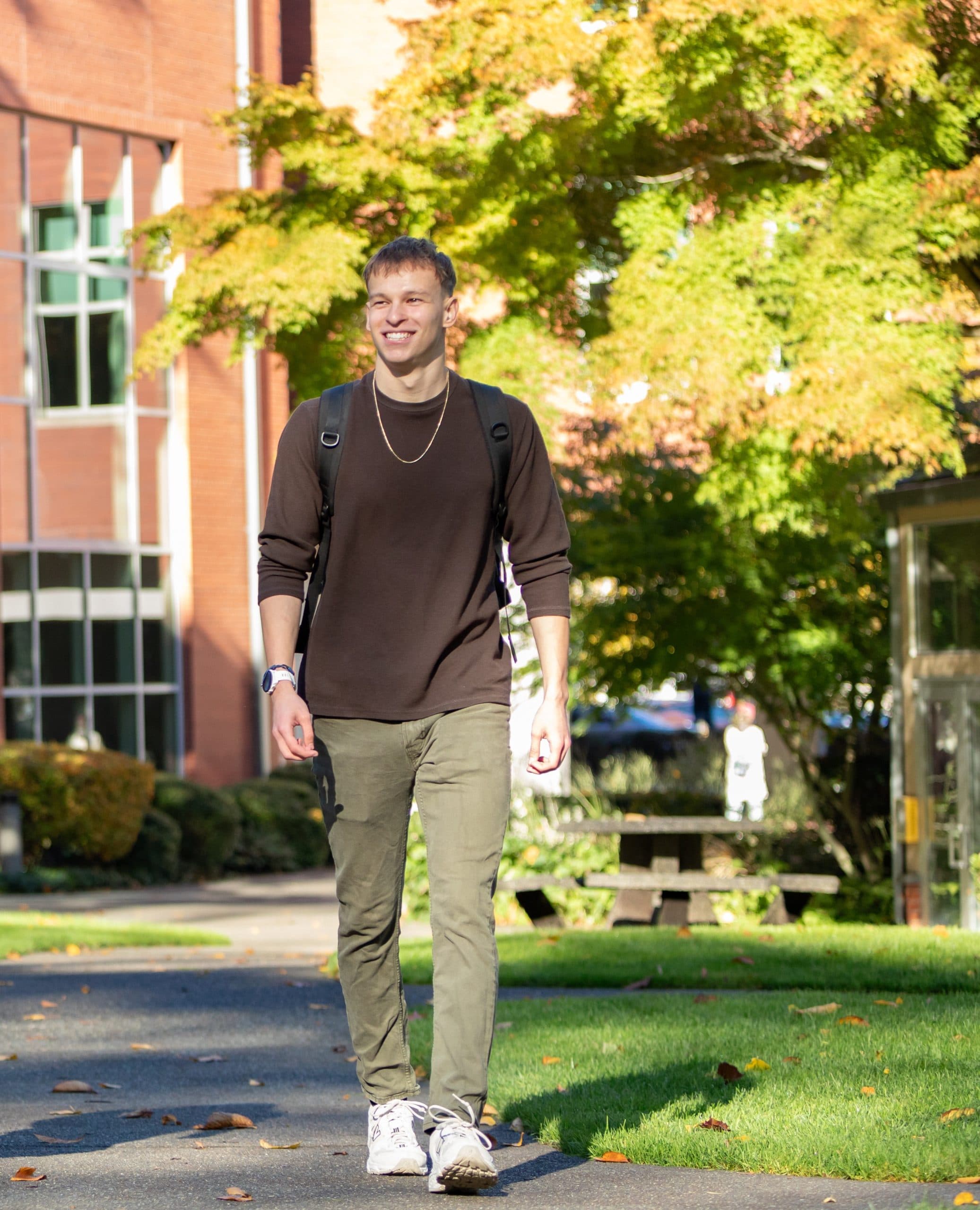 Photo of Silas walking on campus.