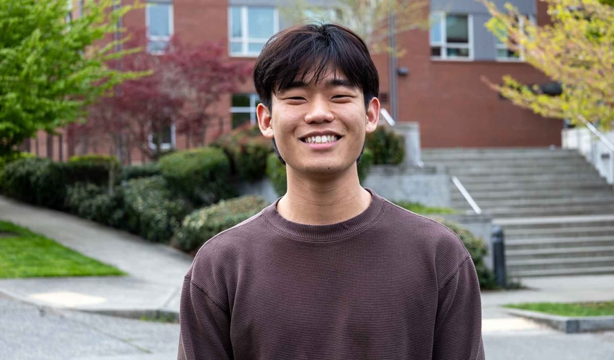 Wideshot of David Lee standing in front of Arnett Hall