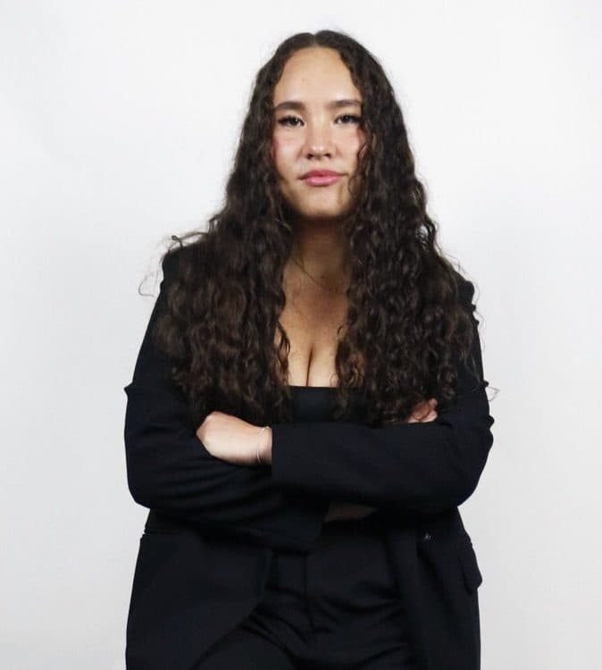 Annabelle Sukin leaning on a stool