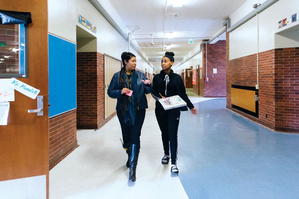 Lisa Lucas strides through the hallway at Seattle’s Jane Addams Middle School