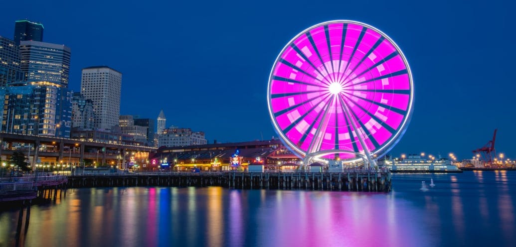Seattle's Great Wheel flashes "SPU 125" in Morse code.