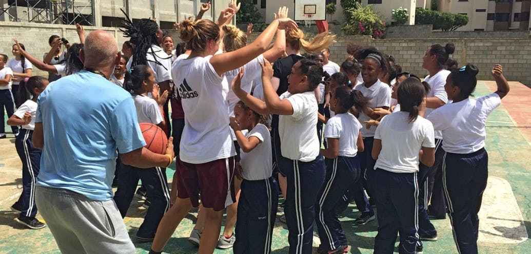 The SPU women’s basketball team members play with kids in the Dominican Republic