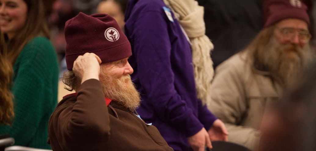 A TC3 resident wears a winter cap sporting SPU's torch.