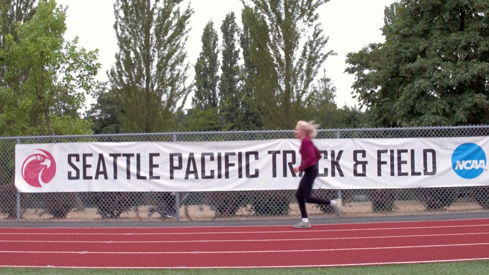 doris runs past spu track & field banner