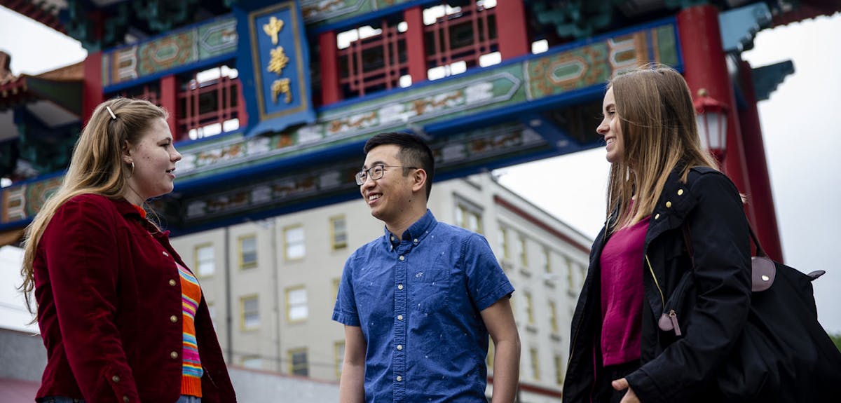 Students talk under the Chinatown gate in Seattle