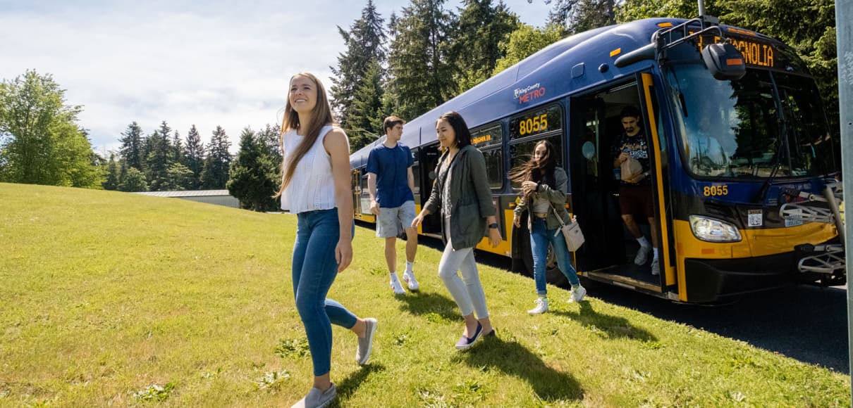 student getting off public bus