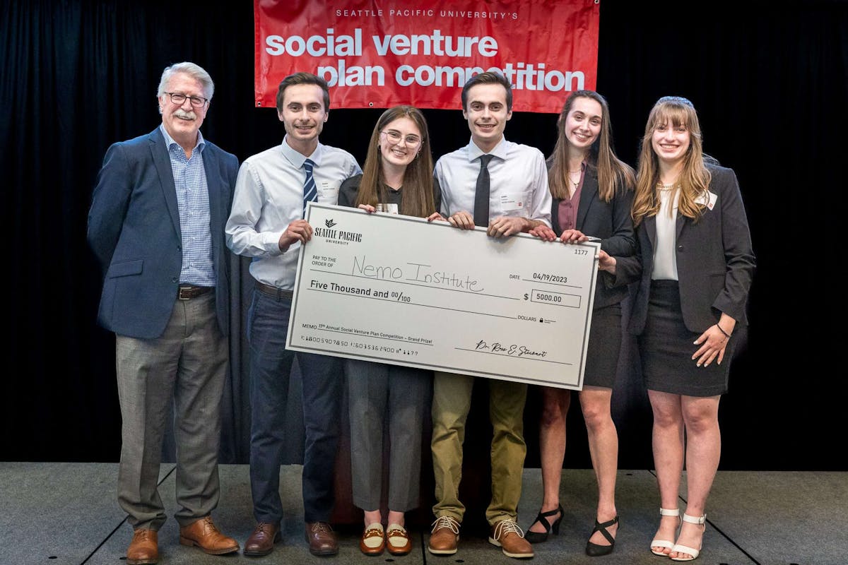 students from team Nemo Institute hold Grand Prize check for $5,000