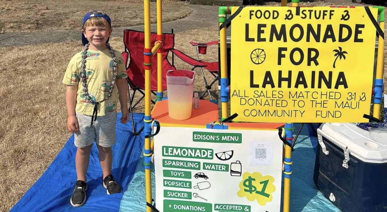 5 year old boy stands next to lemonade for Lahaina stand.
