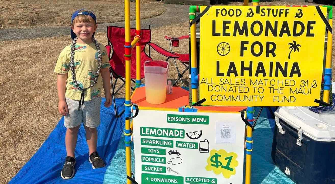 5 year old boy stands next to lemonade for Lahaina stand.